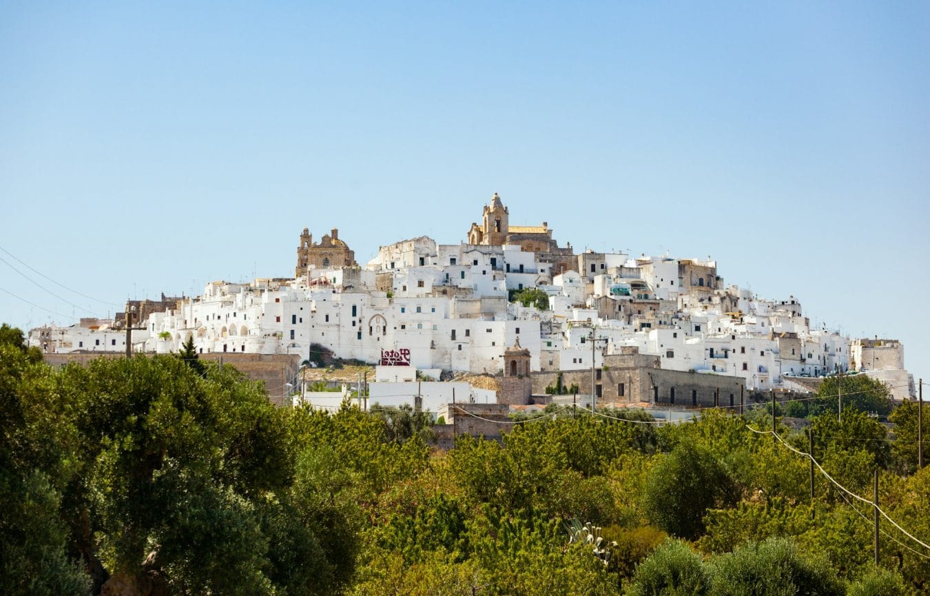 Panoramic view of the white and old city of Ostuni on a hilltop and with the cathedral on top