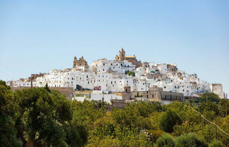 Panoramic view of the white and old city of Ostuni on a hilltop and with the cathedral on top