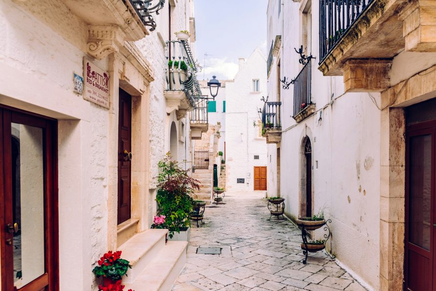 Streets with houses with whitewashed walls of the typical Italian city of Locorotondo.